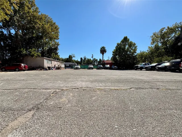 a view of road with a car parked in the background
