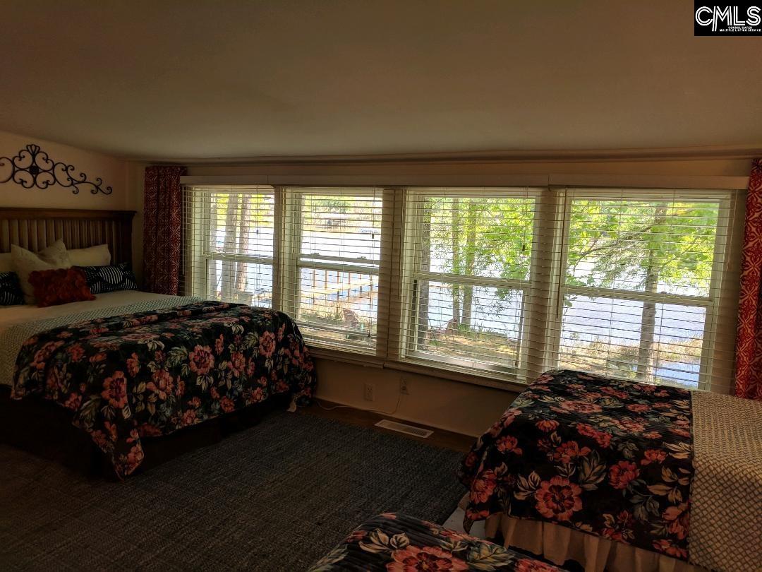957 Rocky Point Circle Ridgeway, SC 29130 - Photo 9 of 23 a bedroom with a bed chair and a large window