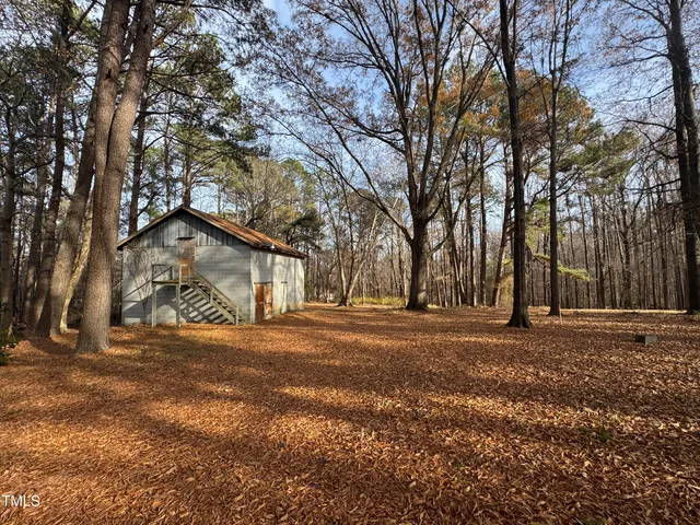 a big yard with lots of green space and trees