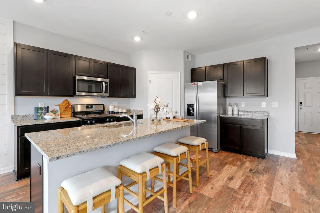 92 Open Gate Lane Shepherdstown, WV 25443 - Photo 12 of 40 a kitchen with stainless steel appliances a stove a sink a microwave a refrigerator and cabinets