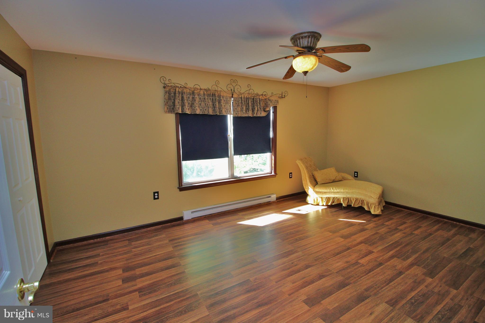 24300 Peach Tree Road Clarksburg, MD 20871 - Photo 22 of 28 a living room with hard wood floors and a window