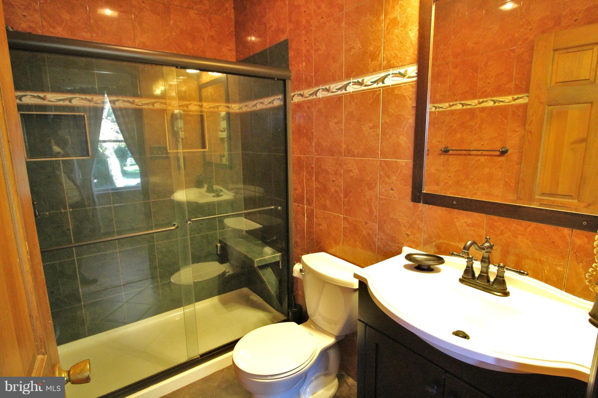 24300 Peach Tree Road Clarksburg, MD 20871 - Photo 4 of 28 a bathroom with a sink toilet and shower