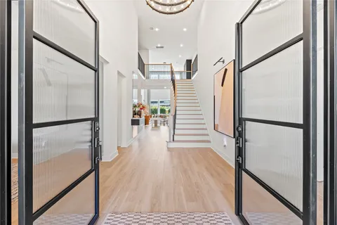 a view of a hallway with wooden floor and staircase
