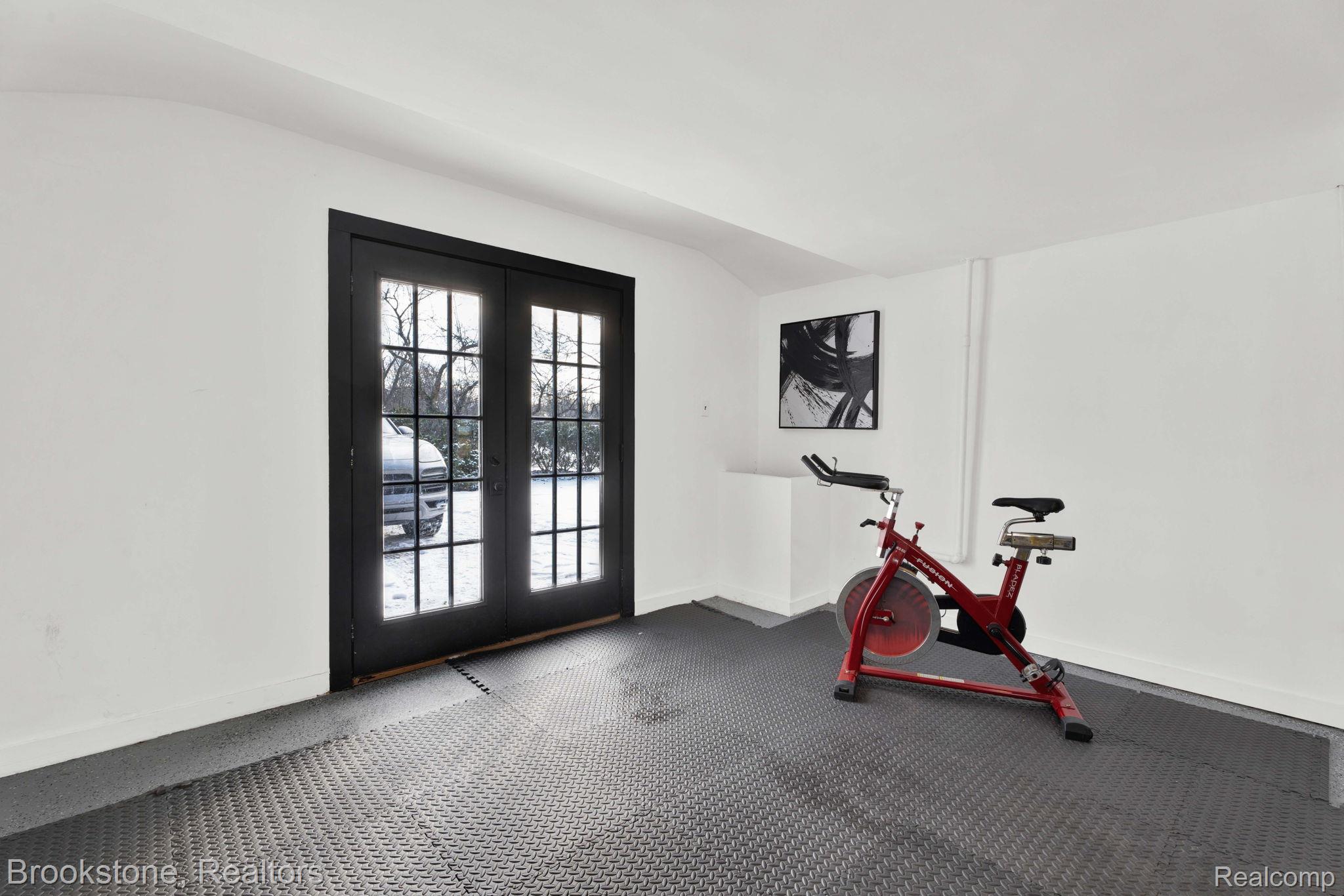 16046 West 13 Mile Road Franklin, MI 48025 - Photo 28 of 31 Exercise area featuring french doors and dark rubber floors