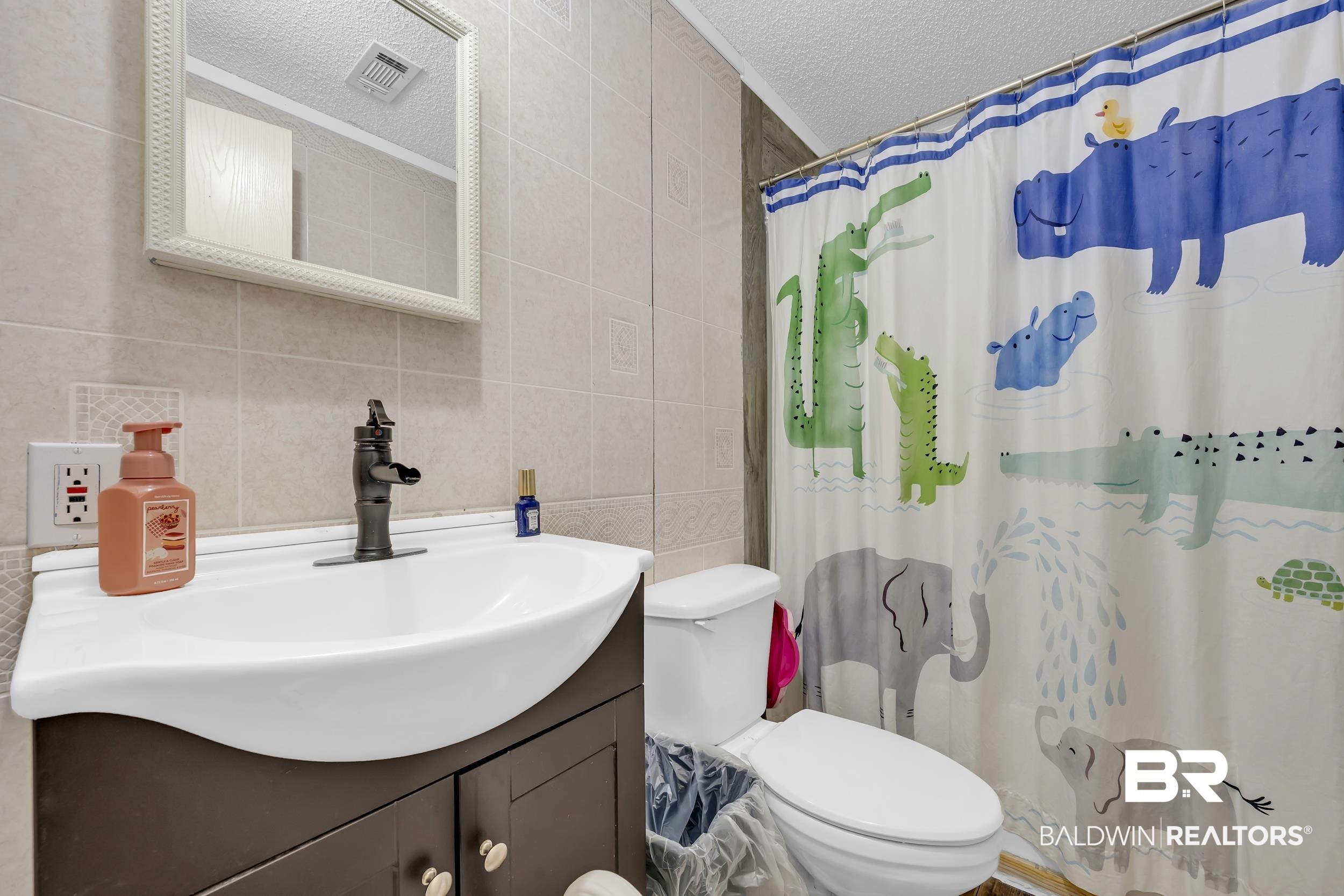 22823 Lanier Road Robertsdale, AL 36567 - Photo 34 of 46 Full bath featuring tile walls, a textured ceiling, and vanity