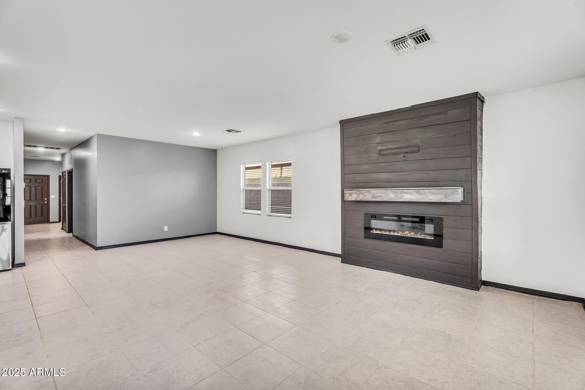 6113 East Athena Road Florence, AZ 85132 - Photo 2 of 19 a view of a livingroom with an empty space and a fireplace