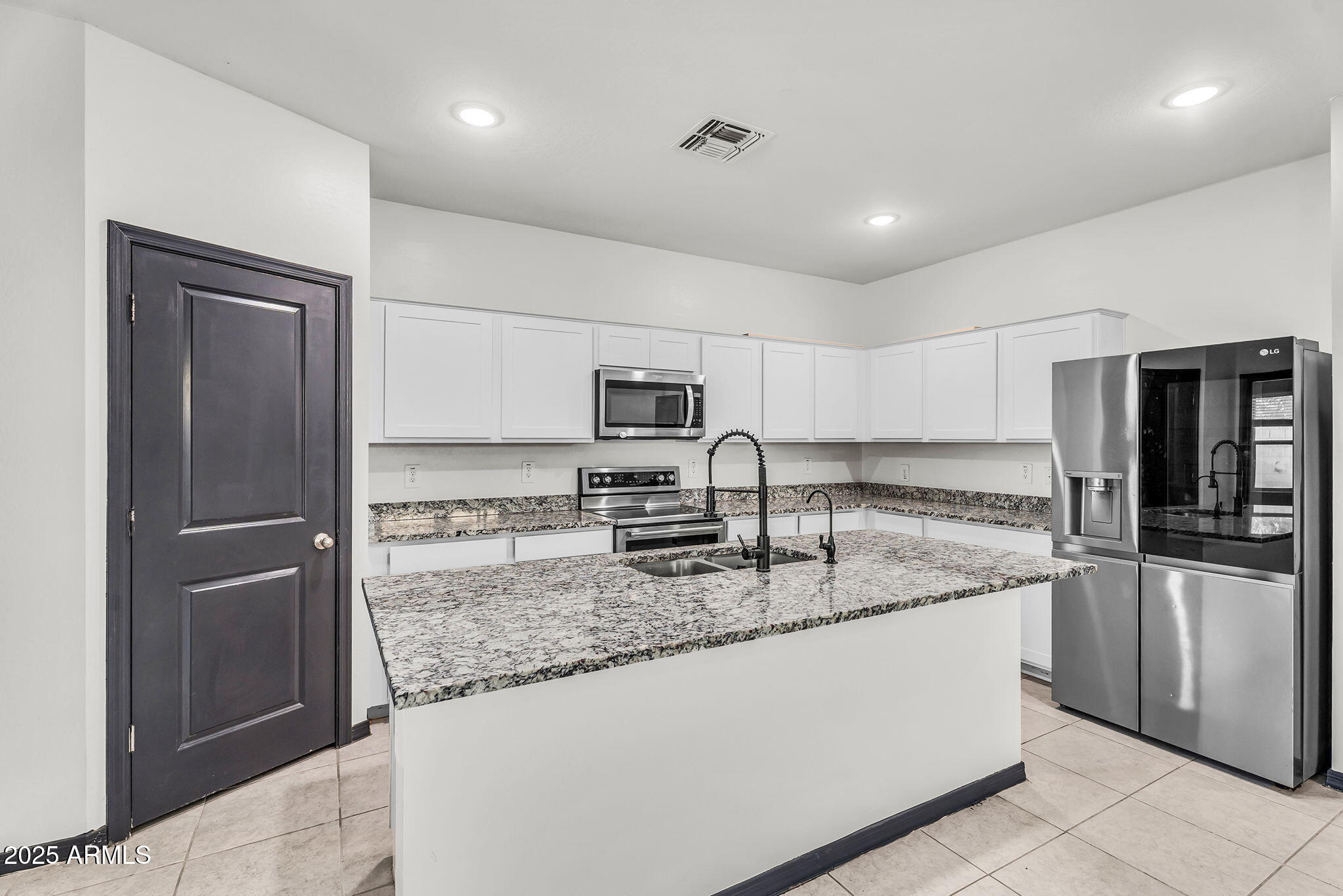6113 East Athena Road Florence, AZ 85132 - Photo 5 of 19 a kitchen with stainless steel appliances granite countertop a refrigerator and a sink