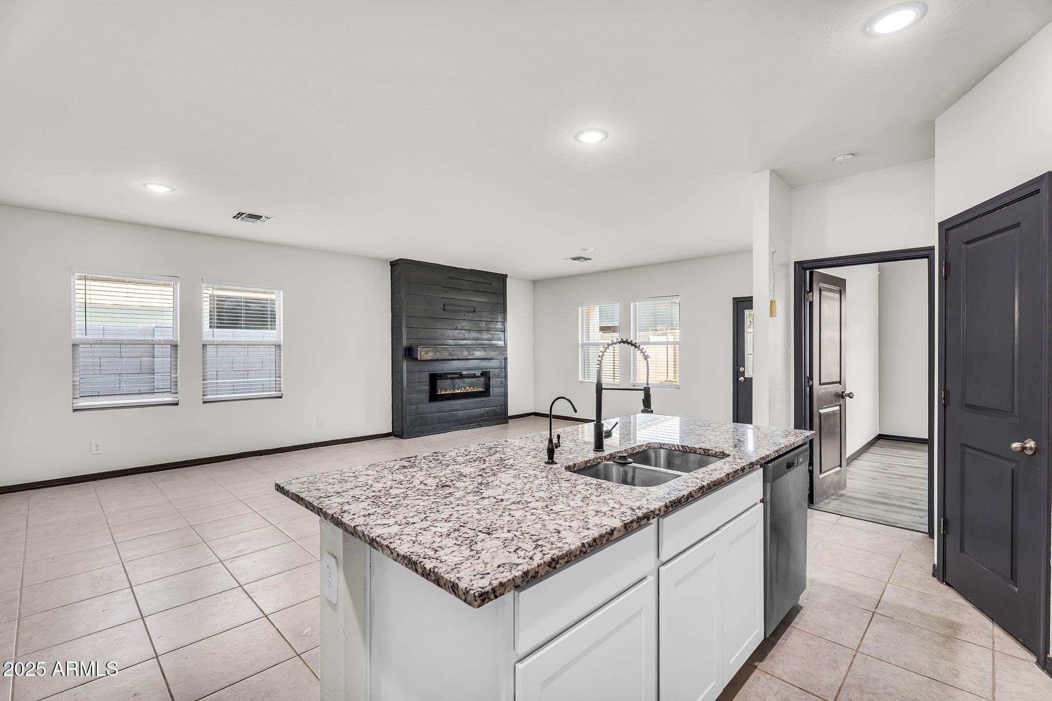 6113 East Athena Road Florence, AZ 85132 - Photo 6 of 19 a kitchen with kitchen island granite countertop a sink stove and refrigerator