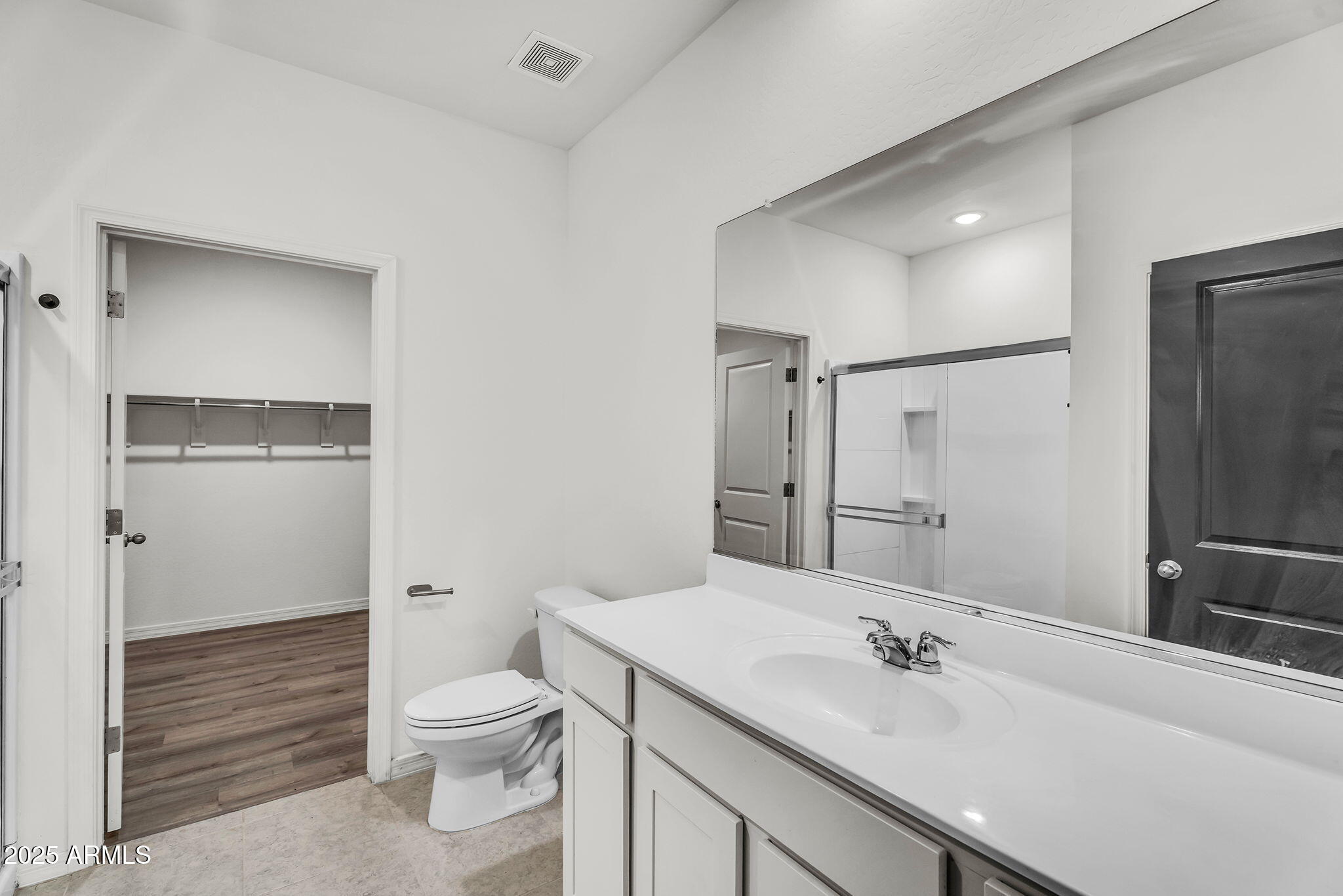 6113 East Athena Road Florence, AZ 85132 - Photo 8 of 19 a bathroom with a granite countertop sink toilet a large mirror and shower