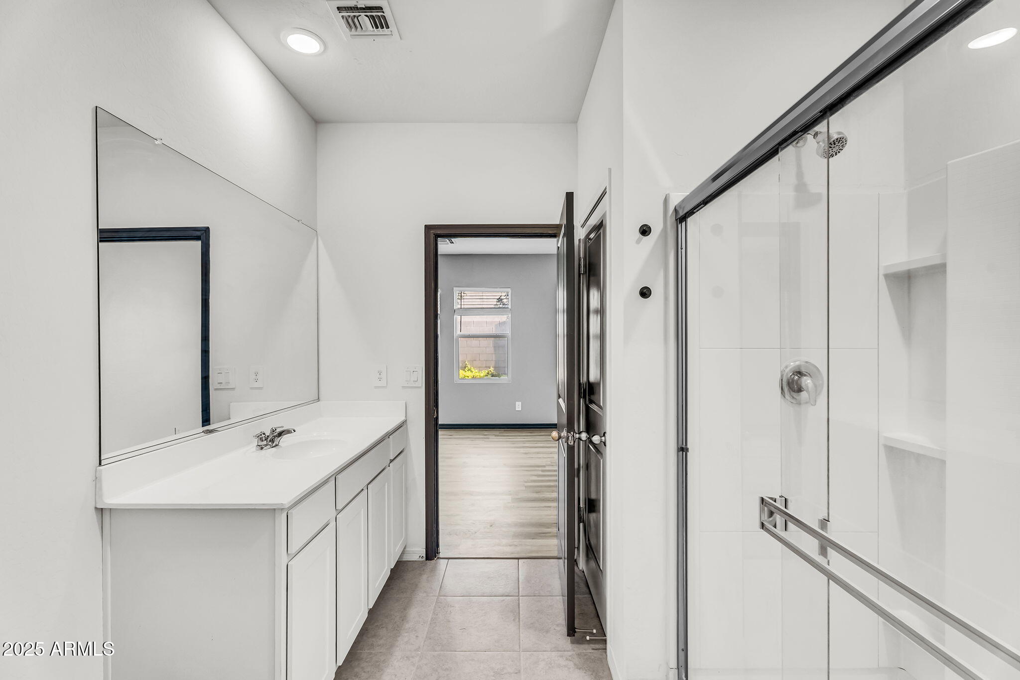 6113 East Athena Road Florence, AZ 85132 - Photo 9 of 19 a bathroom with a double vanity sink and mirror