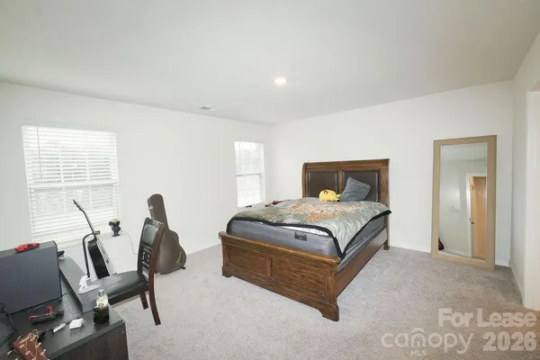a bedroom with a bed and a chair