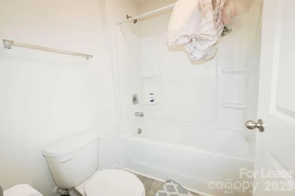 a bathroom with a toilet and a bathtub