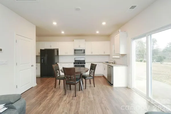 a view of a dining room with furniture and wooden floor