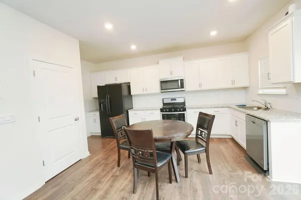 a view of kitchen with table and chairs
