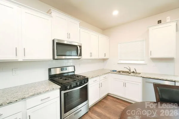 a kitchen with a sink stove and microwave