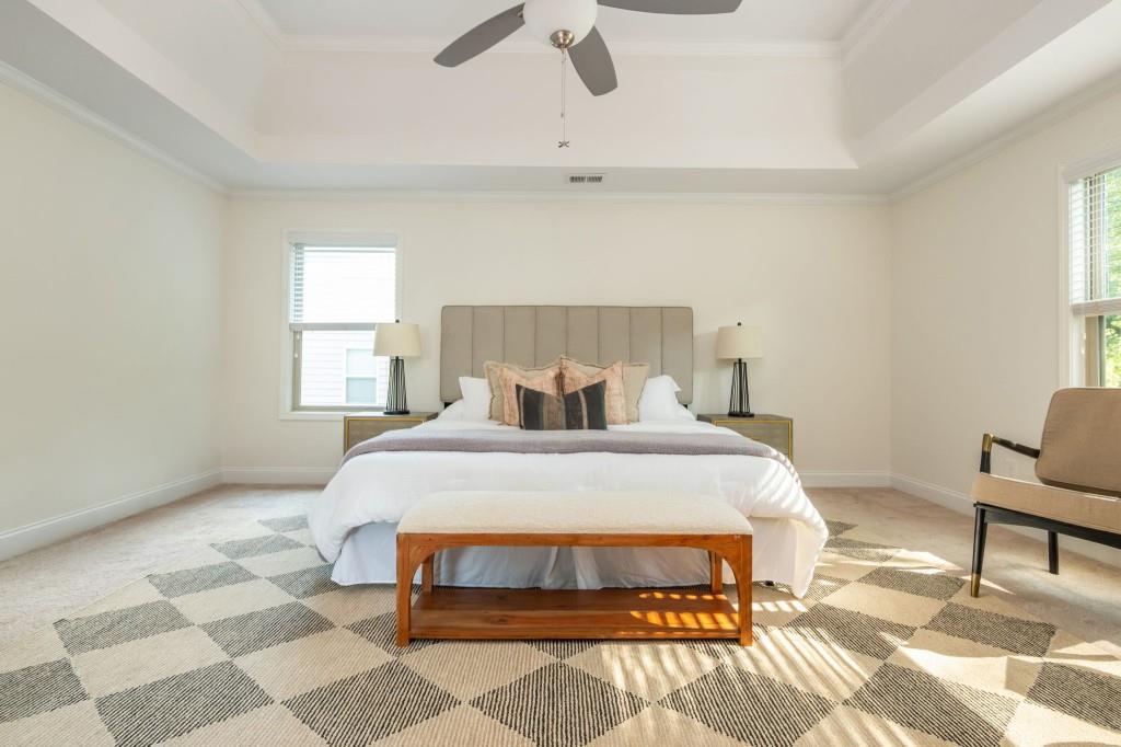 371 Hooper Street Southeast Atlanta, GA 30317 - Photo 19 of 29 a bedroom with a bed and a chandelier