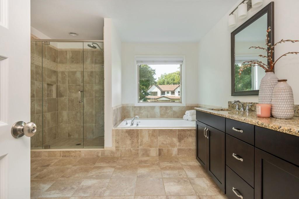 371 Hooper Street Southeast Atlanta, GA 30317 - Photo 21 of 29 a bathroom with a granite countertop sink a toilet and shower