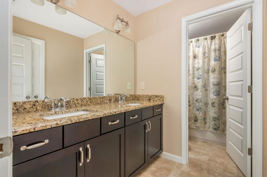 371 Hooper Street Southeast Atlanta, GA 30317 - Photo 24 of 29 a bathroom with a granite countertop sink and a mirror