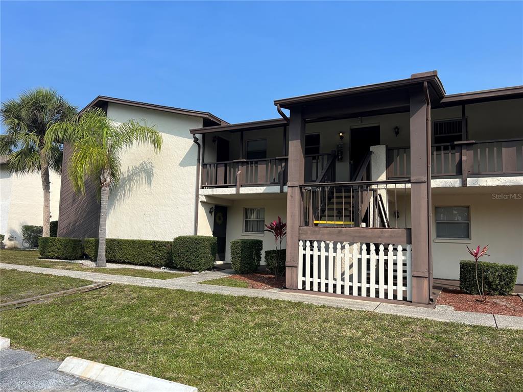 5521 Bay Boulevard, Unit 105 Port Richey, FL 34668 - Photo 1 of 15 a front view of a house having yard