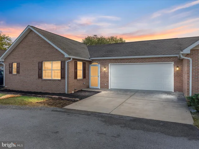 a view of a house with roof and sitting area