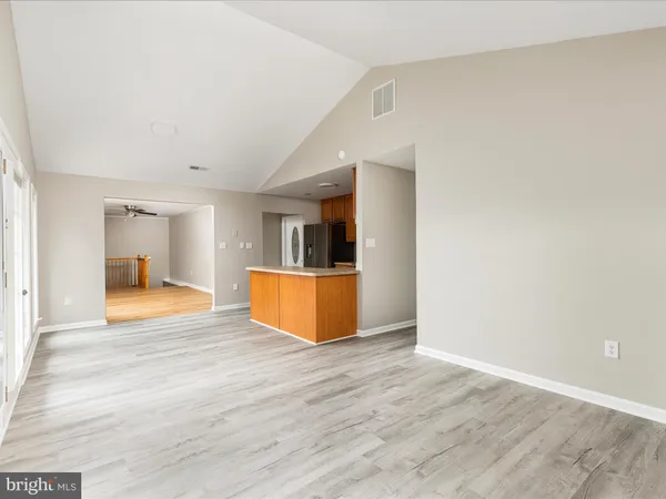 a kitchen with stainless steel appliances granite countertop a refrigerator a stove top oven a sink and dishwasher