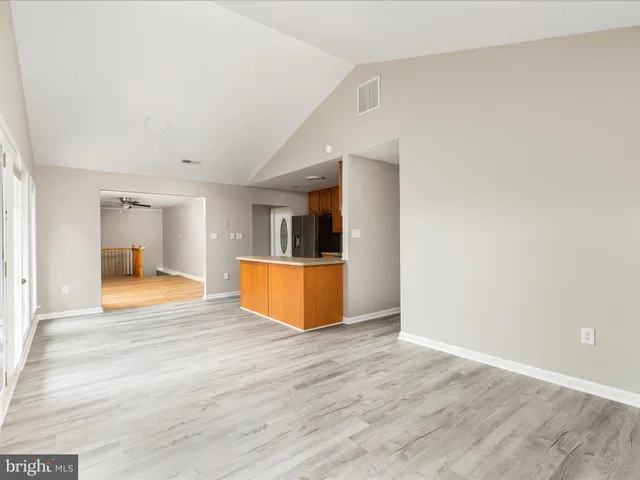 a kitchen with stainless steel appliances granite countertop a refrigerator a stove top oven a sink and dishwasher