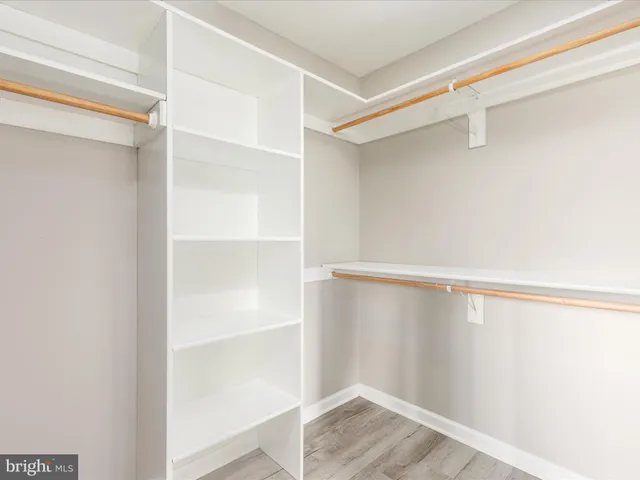 an empty room with ceiling fan and window