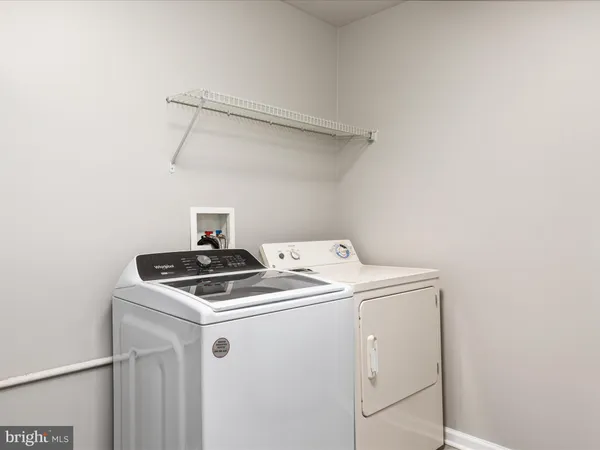 a bathroom with a toilet a sink a mirror and bathtub