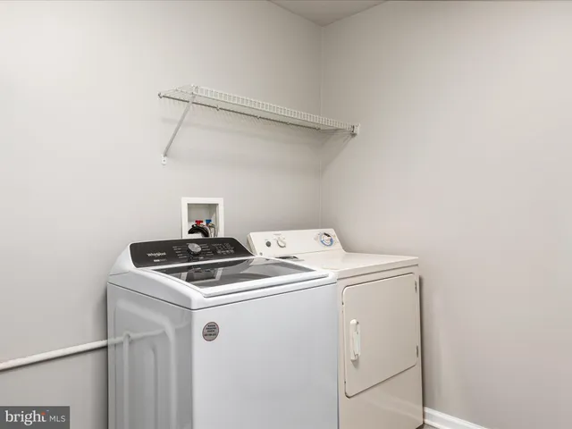 a bathroom with a toilet a sink a mirror and bathtub