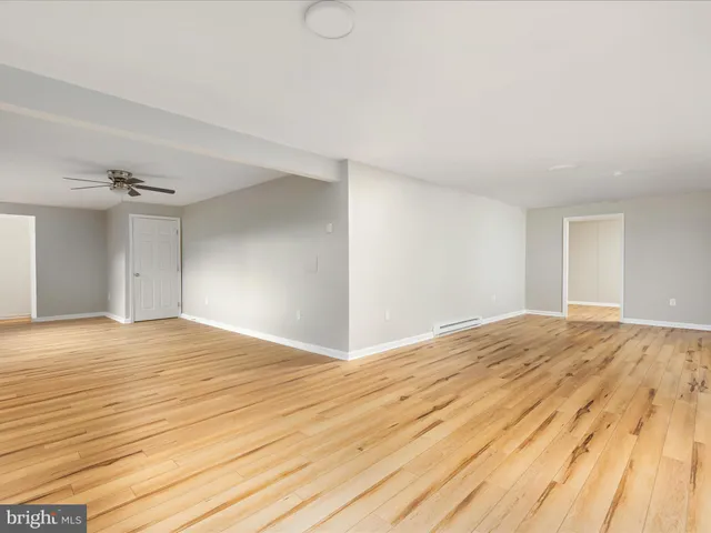 a view of a livingroom with a ceiling fan and window