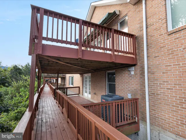 a view of a house with wooden deck