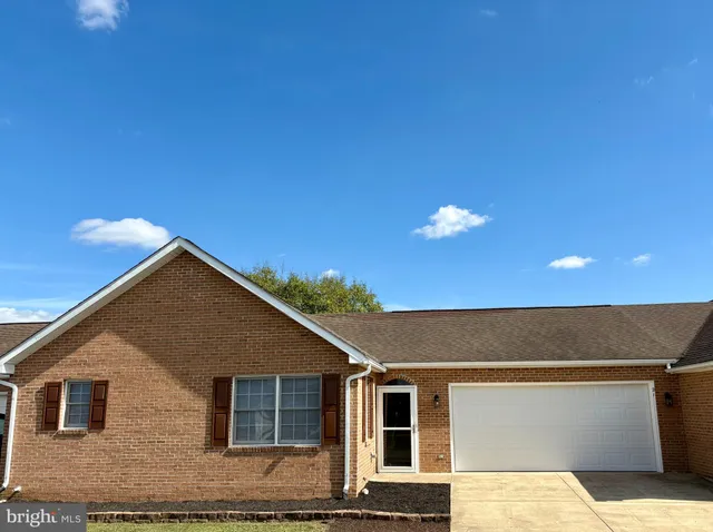 a view of a house with a yard and garage