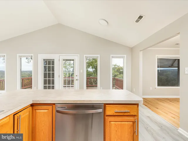 a kitchen with stainless steel appliances granite countertop a sink stove and wooden cabinets