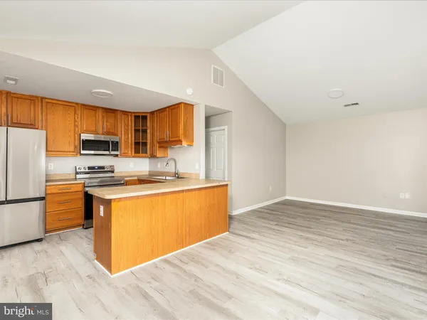 a view of a kitchen counter top space and wooden floor