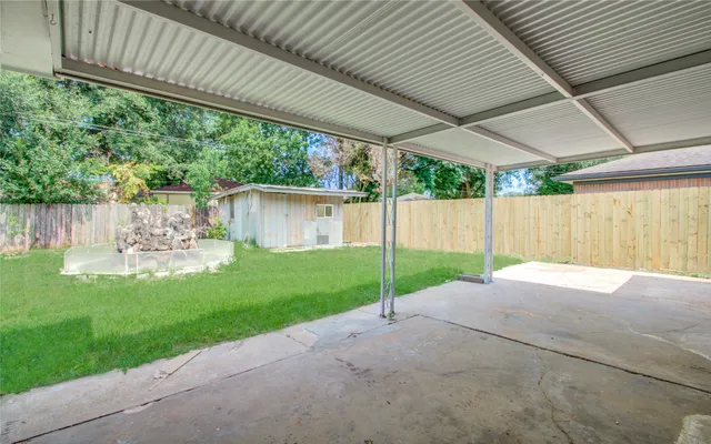 a view of a backyard with plants and a garden