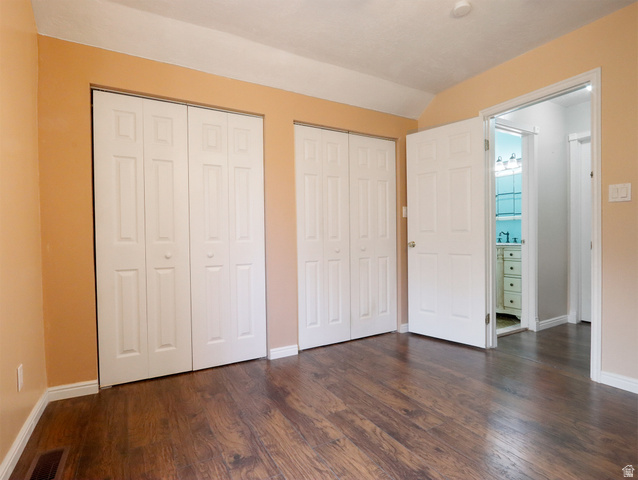 270 East 100 North Monroe, UT 84754 - Photo 32 of 65 Interior room featuring wood-finish flooring, two sets of white bi-fold closet doors, and light tan wall paint
