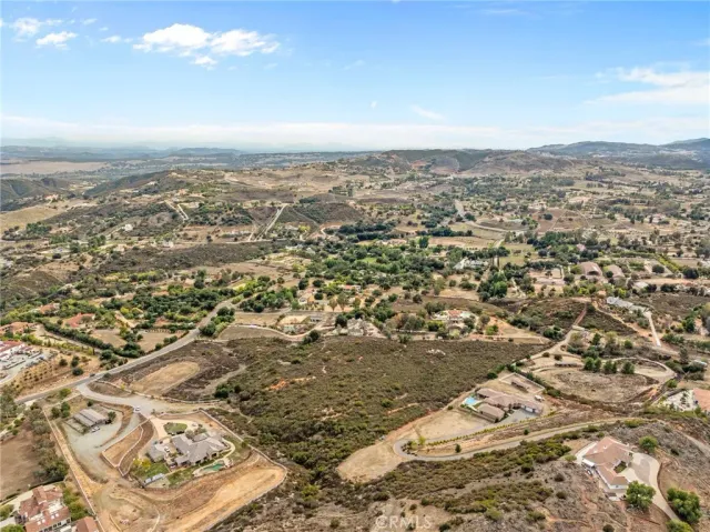 an aerial view of residential building with yard