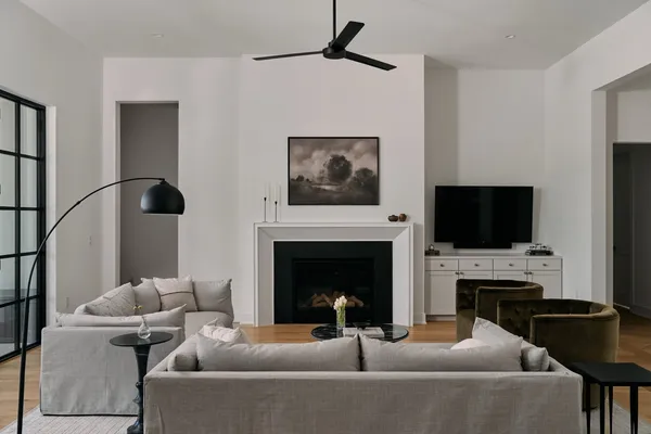 a living room with furniture a fireplace and a flat screen tv