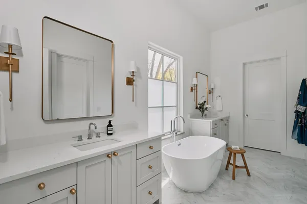 a bathroom with a double vanity sink mirror and toilet