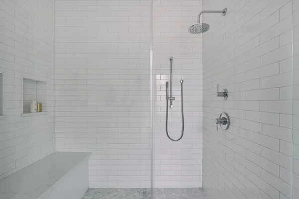 a bedroom with a bed lamp and with a couch