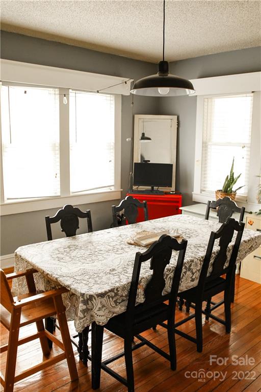 1052 Greenwood Road Spruce Pine, NC 28777 - Photo 16 of 43 a dining room with a wooden table and chairs