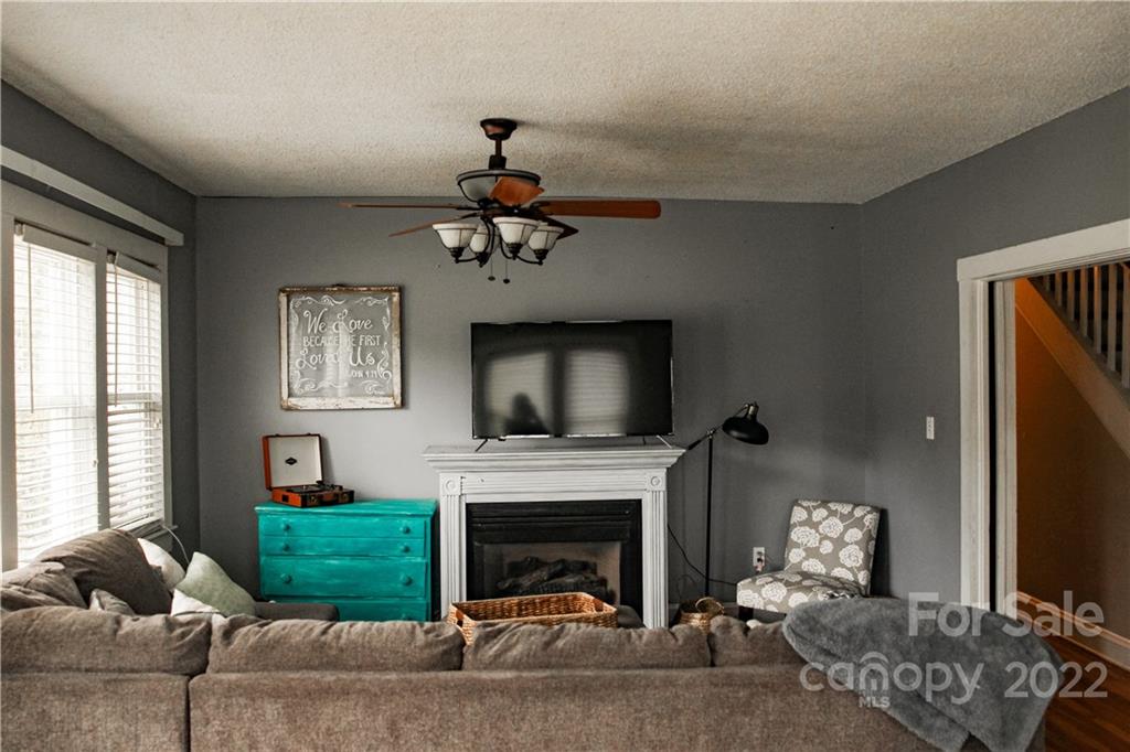 1052 Greenwood Road Spruce Pine, NC 28777 - Photo 21 of 43 a living room with furniture a fireplace and a flat screen tv