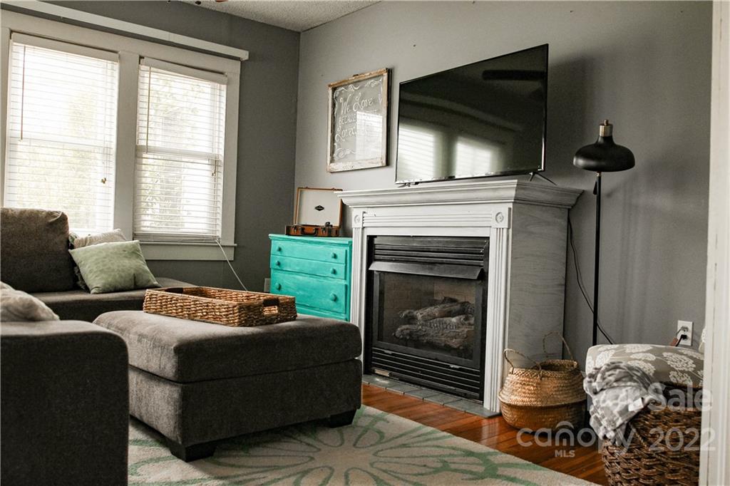 1052 Greenwood Road Spruce Pine, NC 28777 - Photo 24 of 43 a living room with furniture a fireplace and a flat screen tv