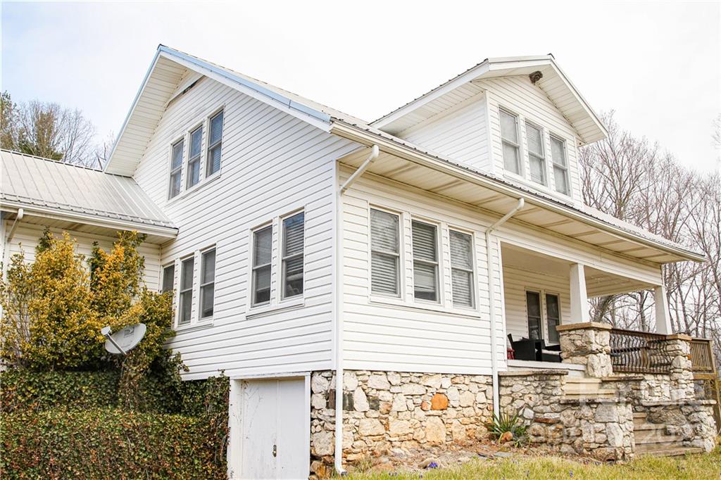 1052 Greenwood Road Spruce Pine, NC 28777 - Photo 3 of 43 a front view of a house with a yard
