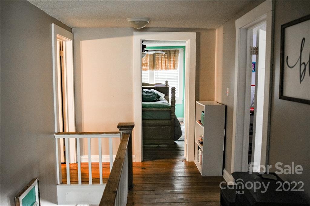 1052 Greenwood Road Spruce Pine, NC 28777 - Photo 38 of 43 a view of a hallway with wooden floor and stairs