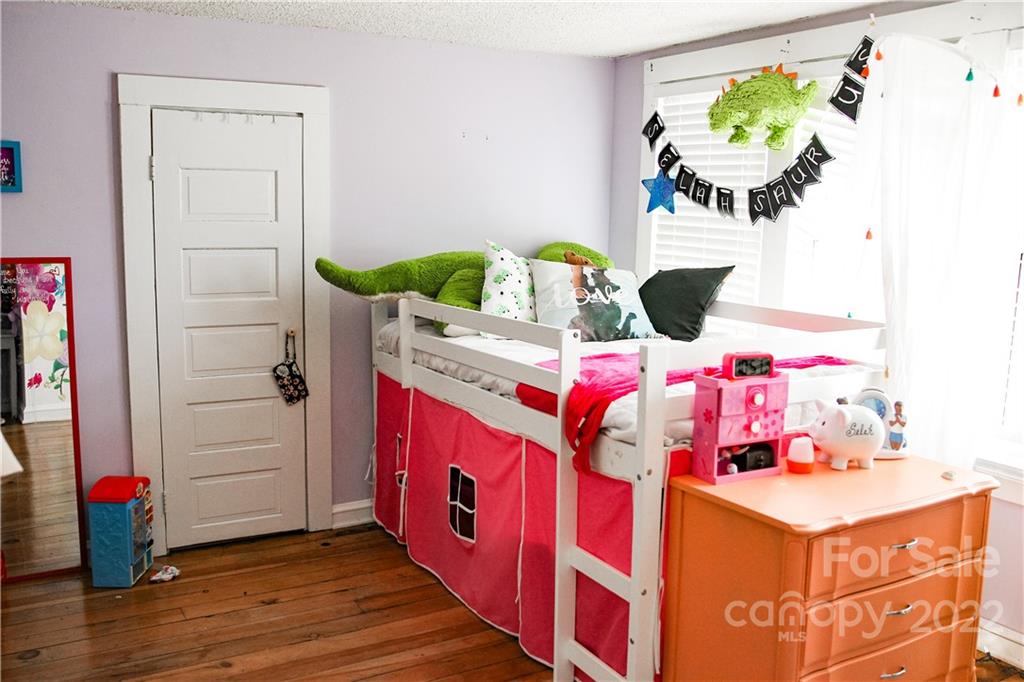1052 Greenwood Road Spruce Pine, NC 28777 - Photo 39 of 43 a bedroom with a bed table and a potted plant