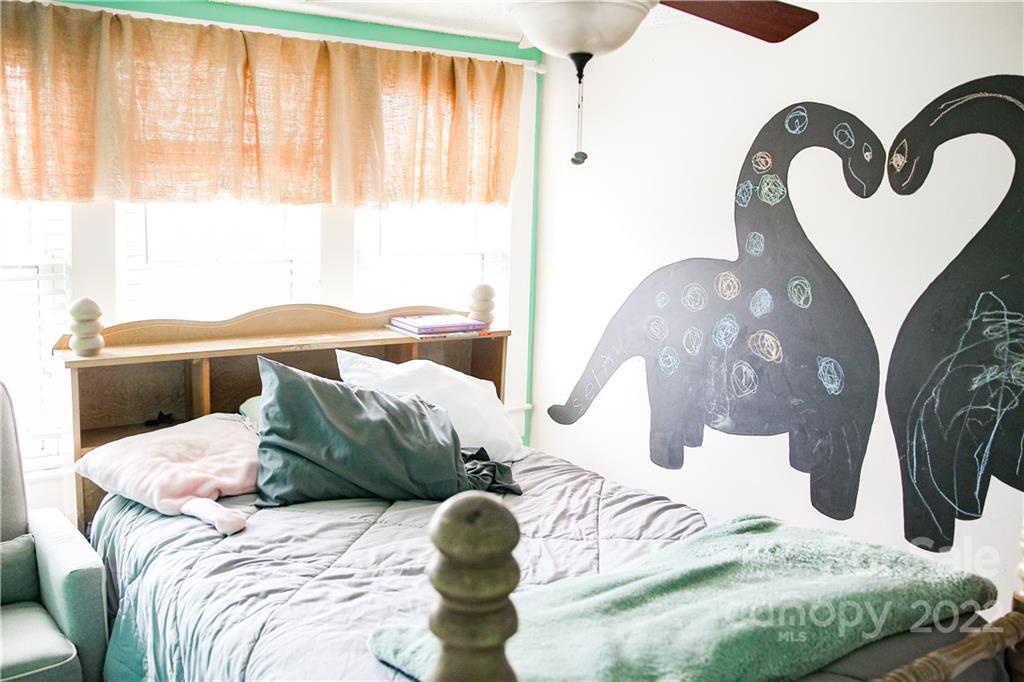 1052 Greenwood Road Spruce Pine, NC 28777 - Photo 41 of 43 a bedroom with a bed and a large mirror