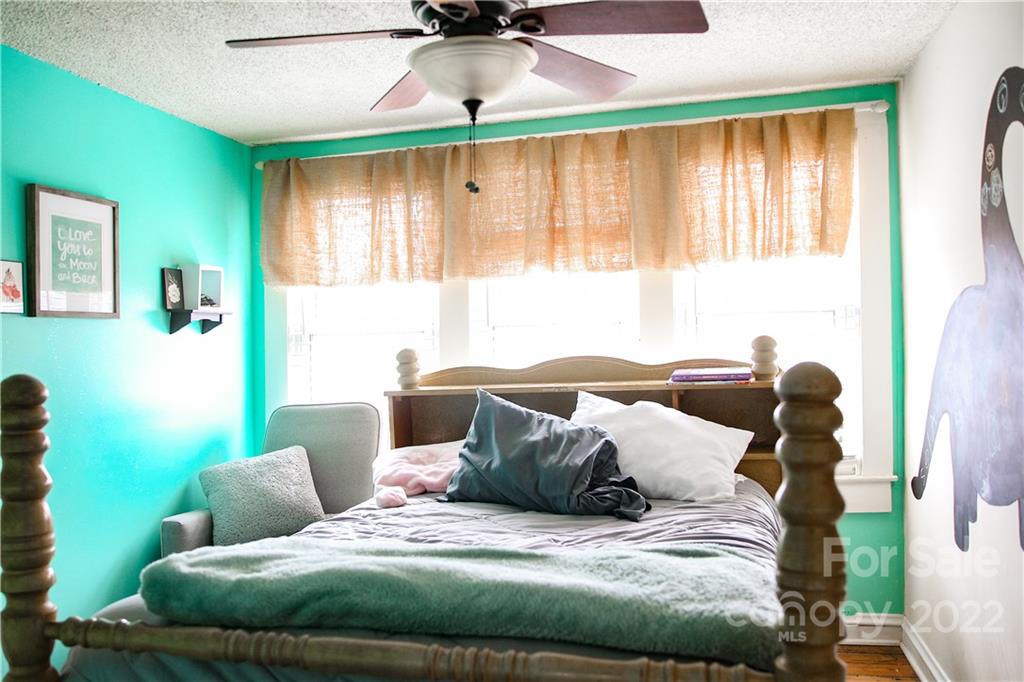 1052 Greenwood Road Spruce Pine, NC 28777 - Photo 42 of 43 a bed sitting in a bedroom next to a window