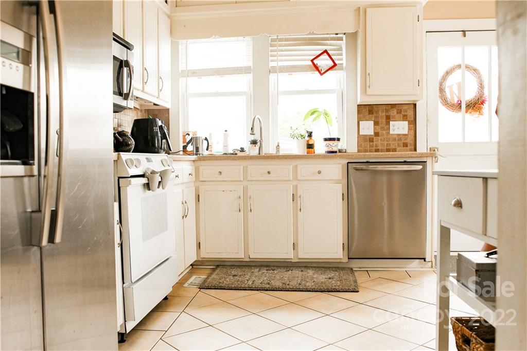 1052 Greenwood Road Spruce Pine, NC 28777 - Photo 9 of 43 a view of a kitchen with granite countertop cabinets and a window