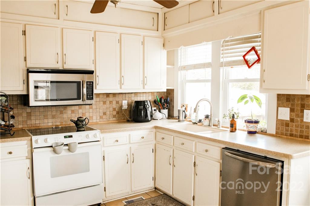 1052 Greenwood Road Spruce Pine, NC 28777 - Photo 10 of 43 a kitchen with appliances cabinets and a sink